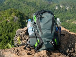 Man Traveler with backpack relaxing outdoor