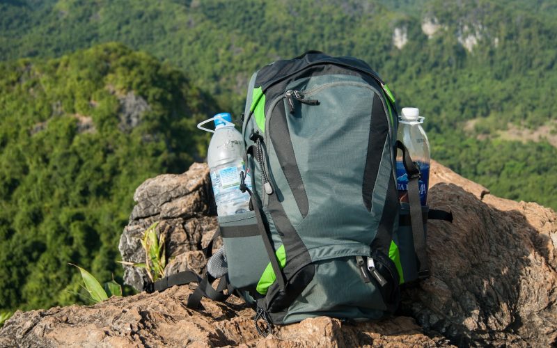 Man Traveler with backpack relaxing outdoor